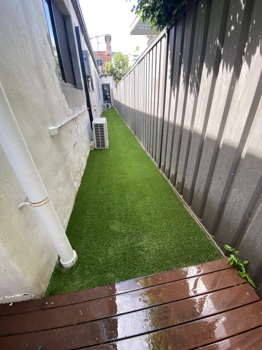 Narrow side path covered in artificial grass